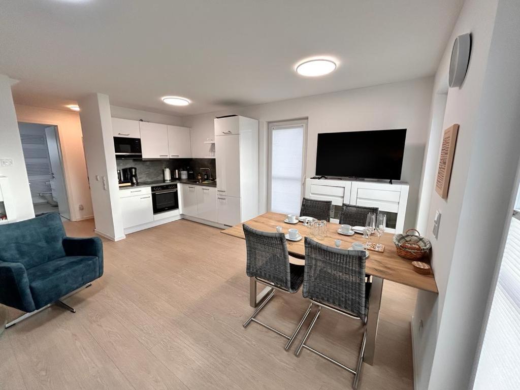a kitchen and dining room with a table and chairs at Wera in Butjadingen
