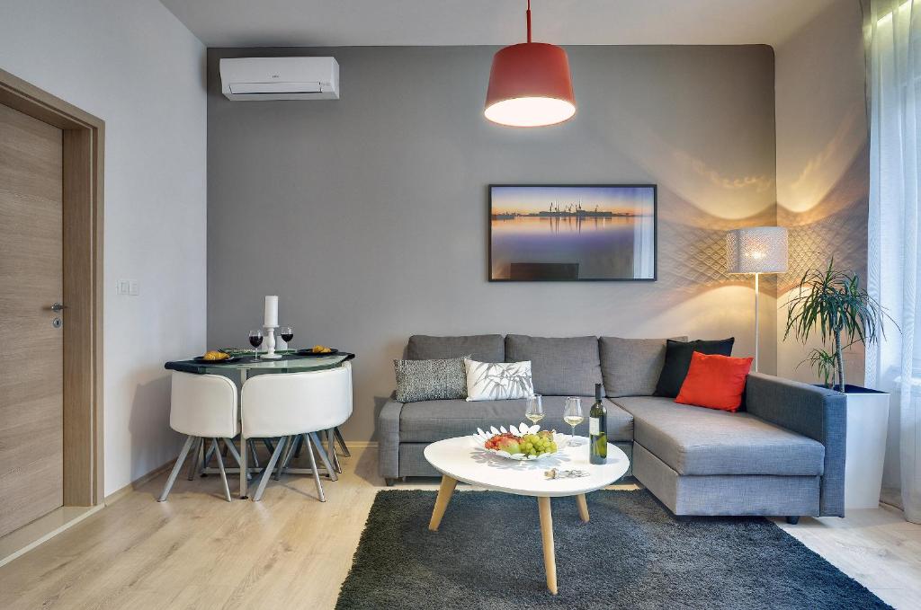 a living room with a couch and a table at D&A Center Apartments with FREE Parking in Pula