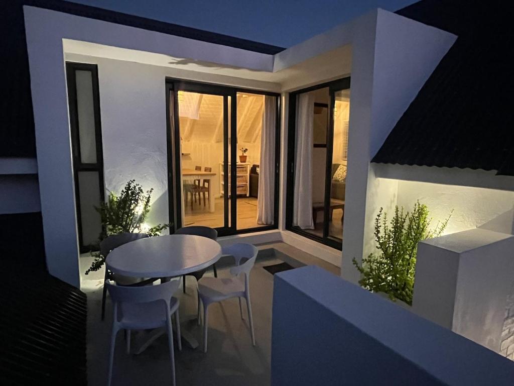 a view of a balcony with a table and chairs at 35 On the Run in St Francis Bay