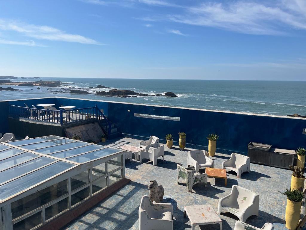 a patio with chairs and a view of the ocean at La Maison des Artistes in Essaouira