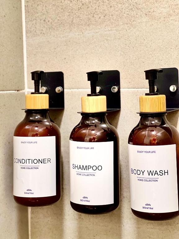 a group of three bottles of honey on a wall at HOTEL 9.5 SAN FERNANDO in Cali