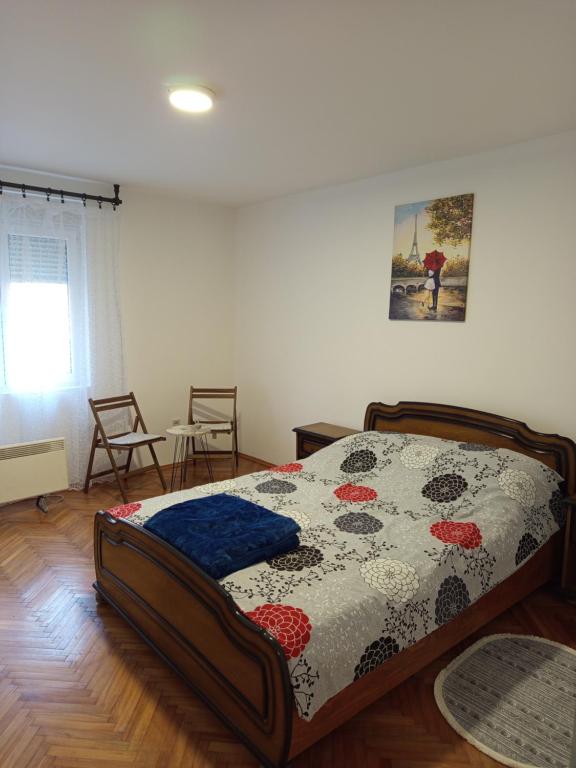 a bedroom with a bed in a room at Stan Na Dan Stević in Niš