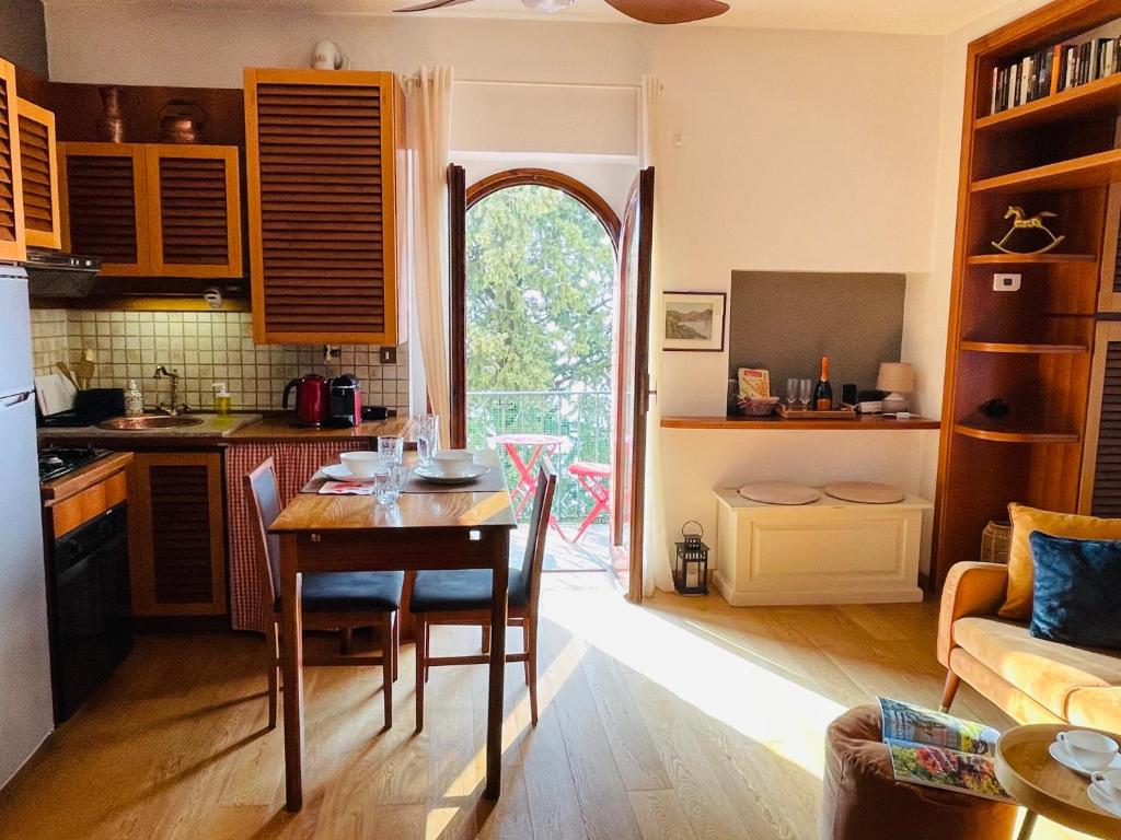 a kitchen and living room with a table and a kitchen and a couch at Lake Front View on Viale GENO in Como