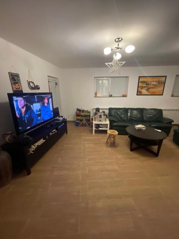 a living room with a couch and a flat screen tv at Günstige und komfortable Wohnung in Regenstauf in Regenstauf