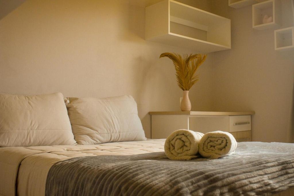 a bedroom with a bed with two towels on it at Casa de temporada - Tatuhouse in José Boiteux