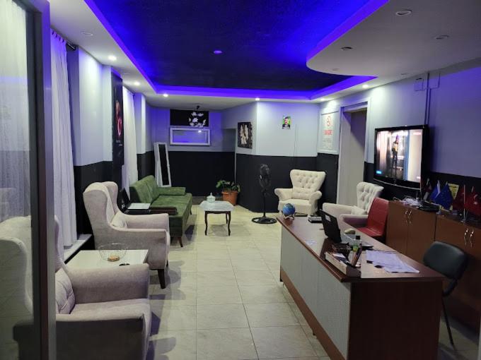 a living room with purple lights on the ceiling at Duygu Otel Konaklama in Karatas