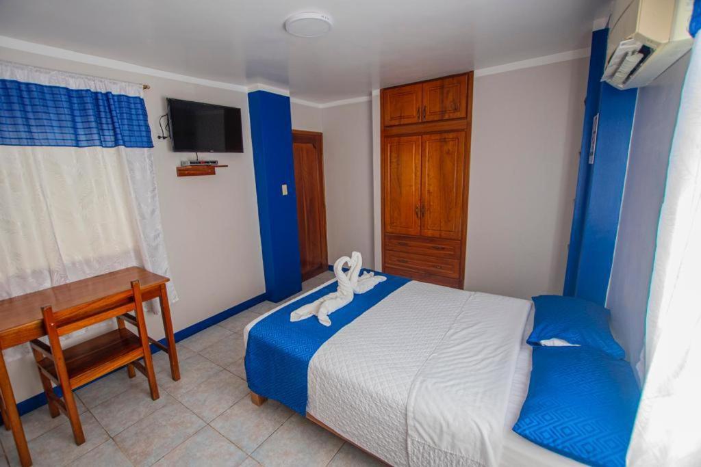 Postel nebo postele na pokoji v ubytování Hostal León Dormido