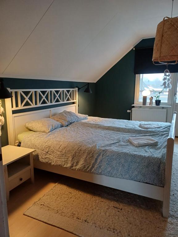 a bedroom with a bed and a window at Villa with hot tub and sauna in Umeå