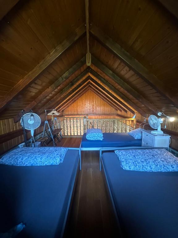 a room with two beds in a wooden cabin at Cottage Plavi Lav Potok in Potok