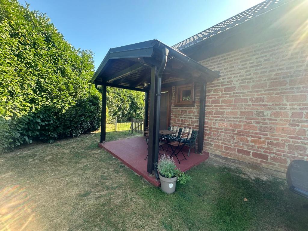 a gazebo with a bench and a table at Cottage Plavi Lav Potok in Potok