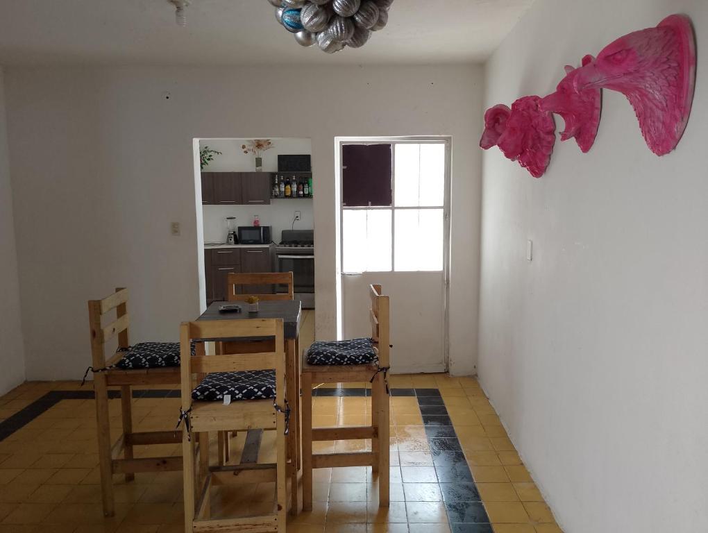 a kitchen with a table and chairs in a room at Habitación exclusiva para hombres LGBT in Mazatlán