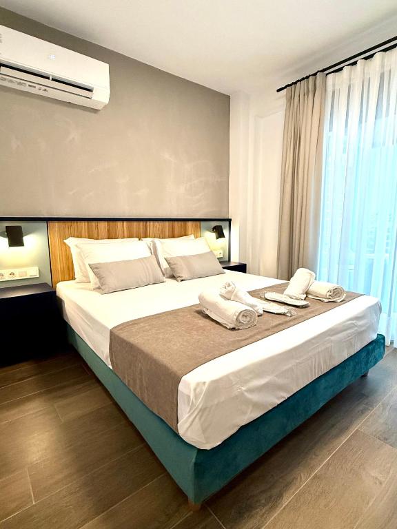 a bedroom with a large bed with towels on it at Diamond A2 in Iraklitsa