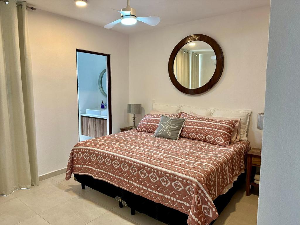 a bedroom with a bed and a mirror at El Firmamento 36f in Mezcales