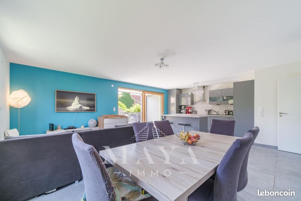 une salle à manger et une cuisine avec une table et des chaises dans l'établissement Appartement - 3 chambres - proche Euroairport, à Sierentz