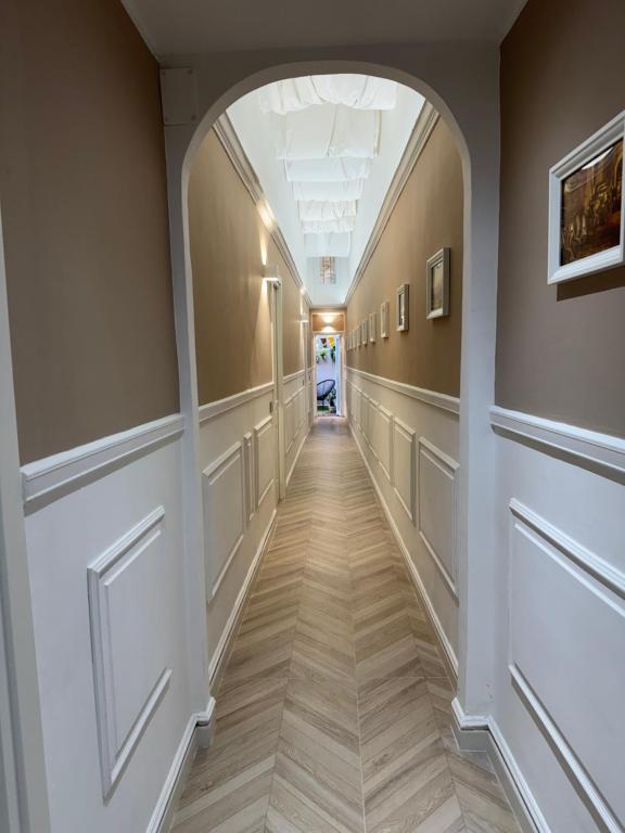 an empty hallway with an archway in a building at NapoliOn - Luxury Apartment in Naples