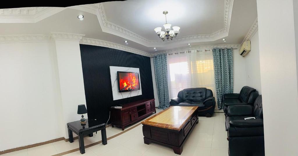 a living room with a couch and a table and chairs at Two- Bedroom Masaki Sea View Retreat in Dar es Salaam