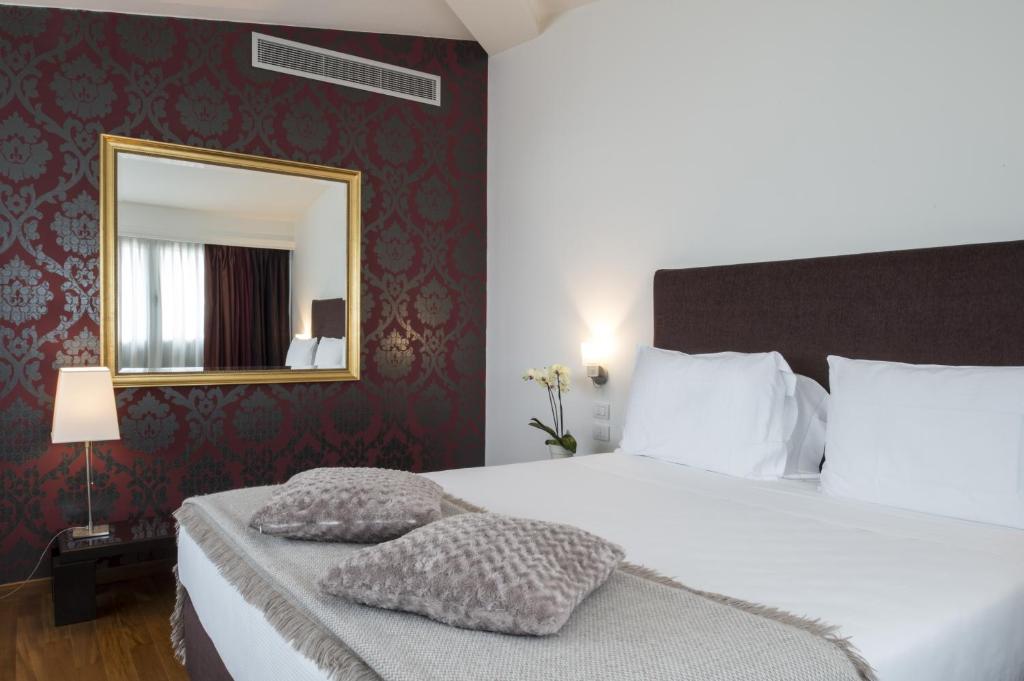 Postel nebo postele na pokoji v ubytování Hotel Maggior Consiglio