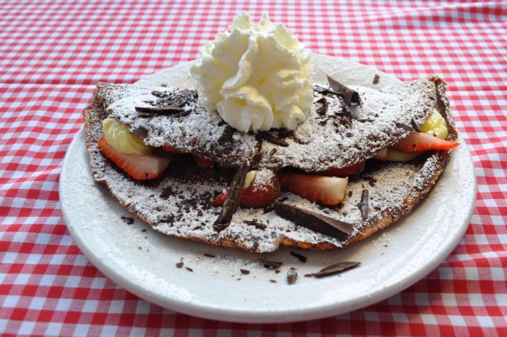 a stack of toast with ice cream on a plate at The Zzzz Moose Camping Cabins in Birch Plain