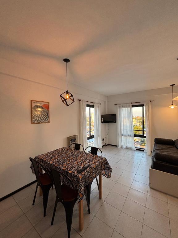 a dining room with a table and a couch at Departamento en el centro de Rafaela in Rafaela
