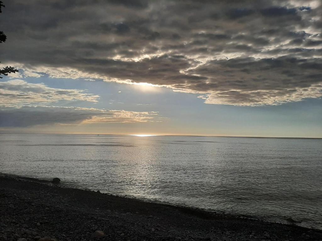 a view of the ocean with a cloudy sky at The Zzzz Moose Camping Cabins in Birch Plain
