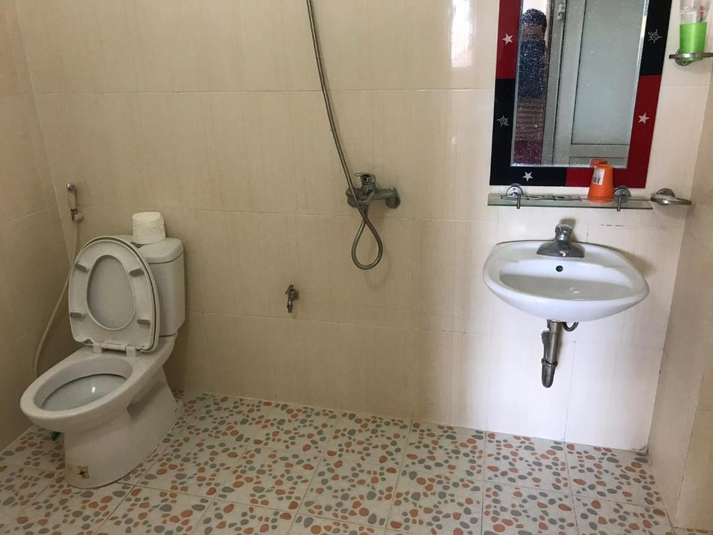 a bathroom with a toilet and a sink at Minh An in Dien Bien Phu