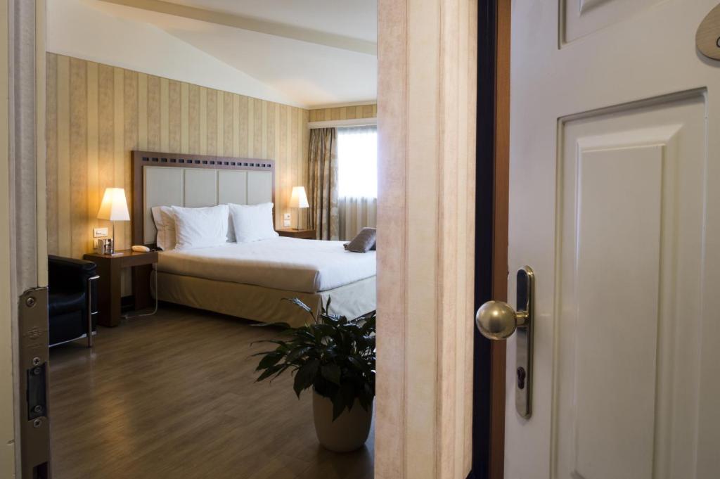 Postel nebo postele na pokoji v ubytování Hotel Maggior Consiglio