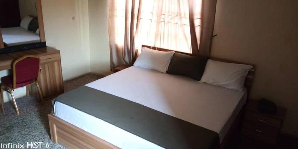 Postel nebo postele na pokoji v ubytování MT4 Hotel