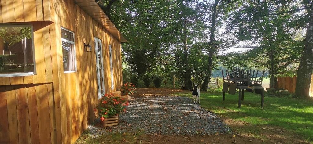 a house with a porch and a bench next to it at La Petite Maison dans La Mégie Tiny House in Troche