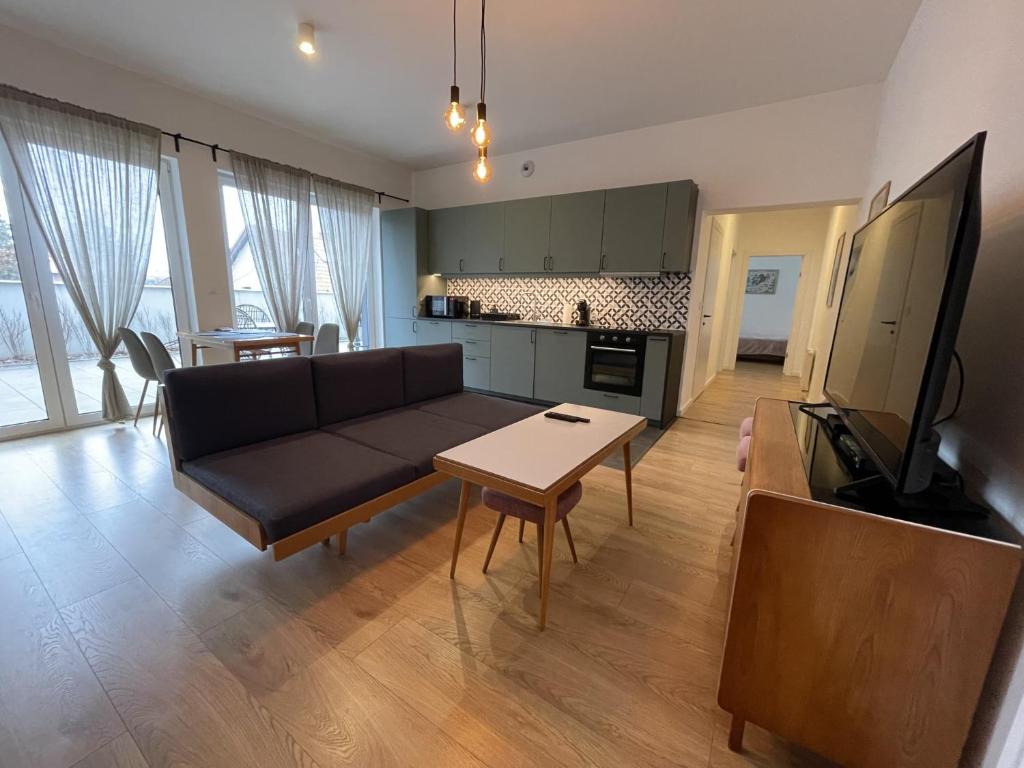 a living room with a couch and a table at APARTAMENT POLANICA RESIDENCE Nr 1 in Polanica-Zdrój