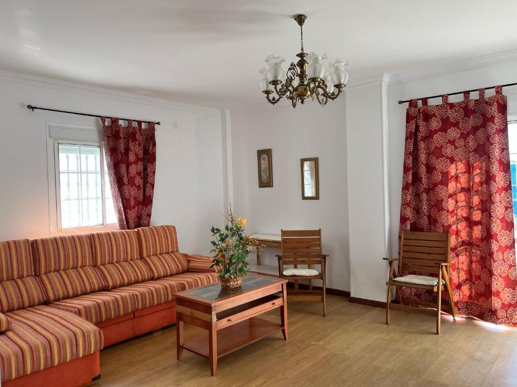 a living room with a couch and a table at Chalet Grande Margarita, 75 in El Puerto de Santa María