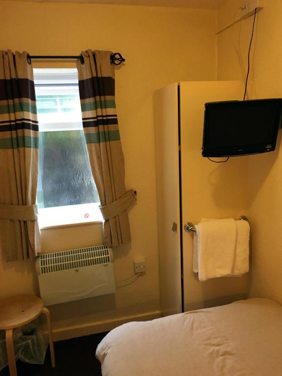 Postel nebo postele na pokoji v ubytování Redbeck Motel