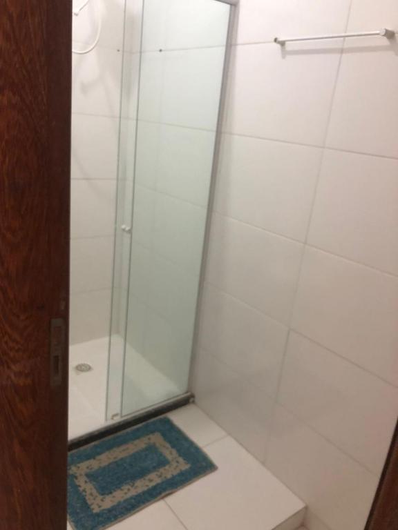 a shower with a glass door in a bathroom at Apto de tuco in Ilhéus