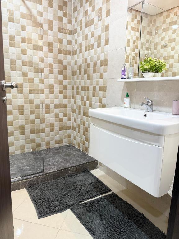 a bathroom with a sink and a shower at The Paradise of ACHAKAR in Tangier