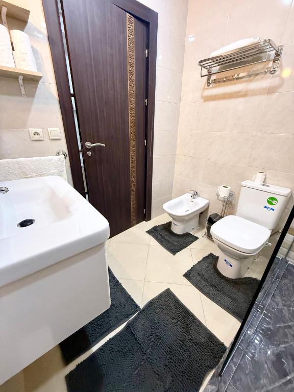a bathroom with a white sink and a toilet at The Paradise of ACHAKAR in Tangier