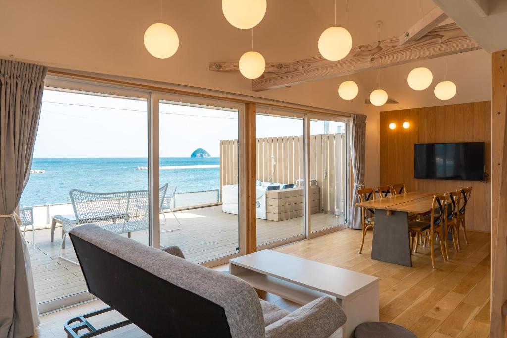 a living room with a view of the ocean at Beach SPA TSUDA 1 Uno in Sanuki