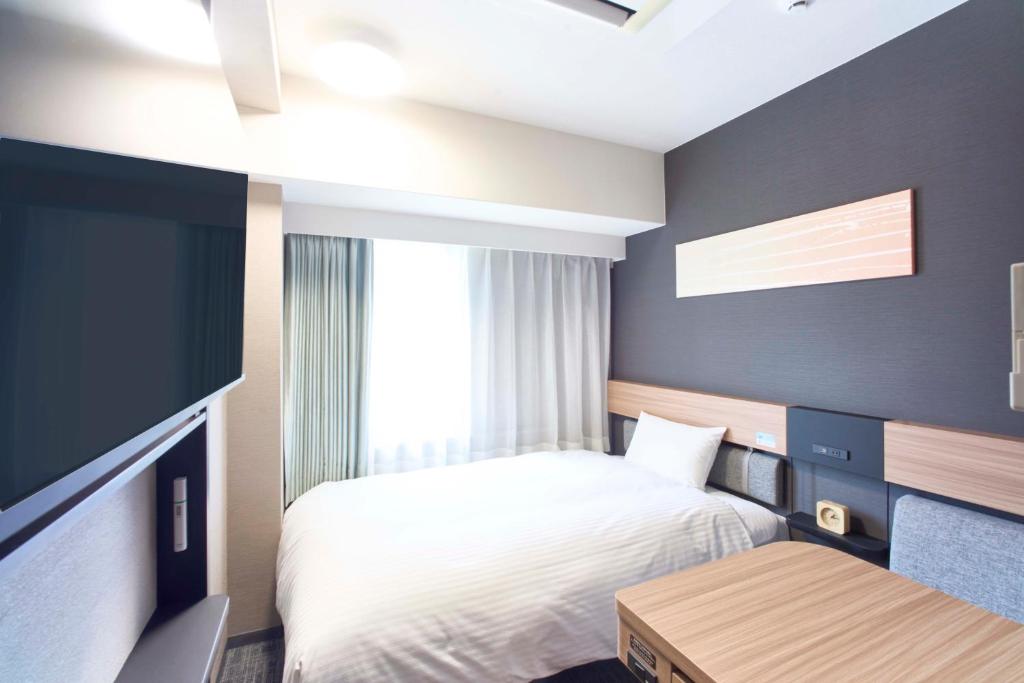 Postel nebo postele na pokoji v ubytování Washington R&B Hotel Kyoto Station Hachijoguchi