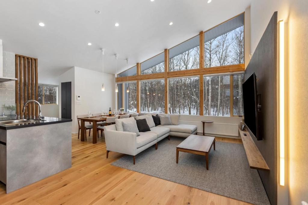 a living room with a couch and a table at Aoyama Lodge 2 in Kutchan