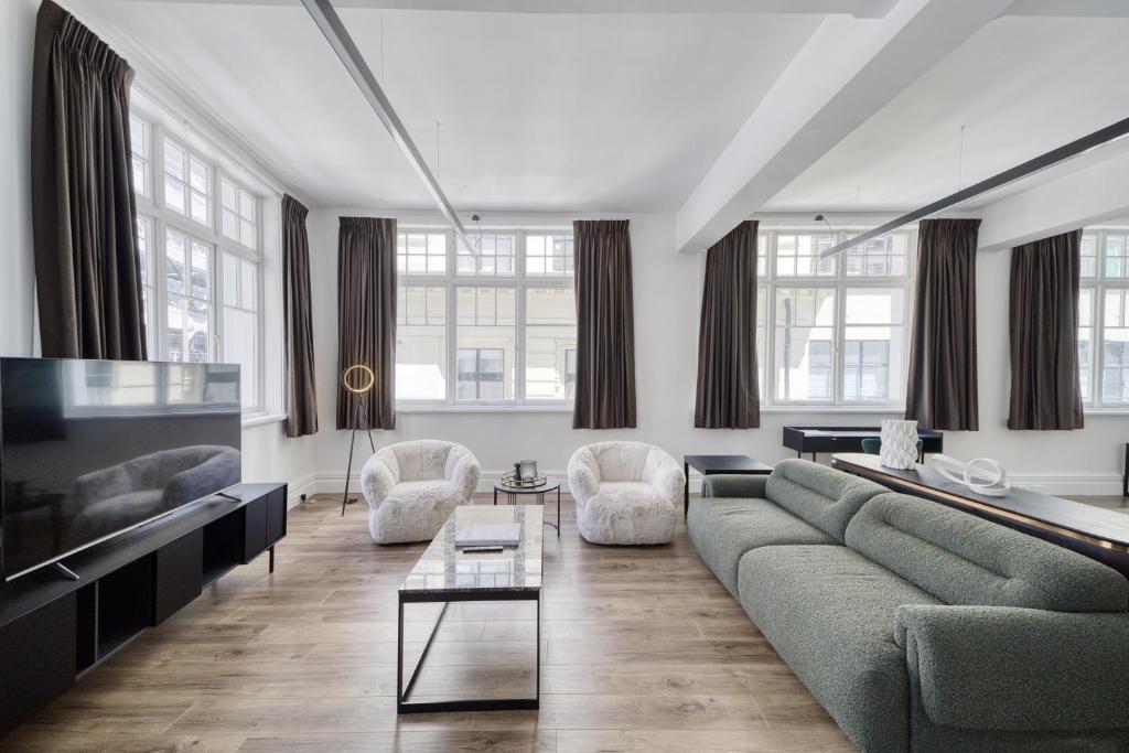 a living room with a couch and a table at High Street Luxury Loft in Auckland