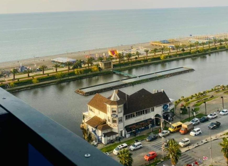 an aerial view of a building next to a body of water at Orbi City - "A" in Batumi