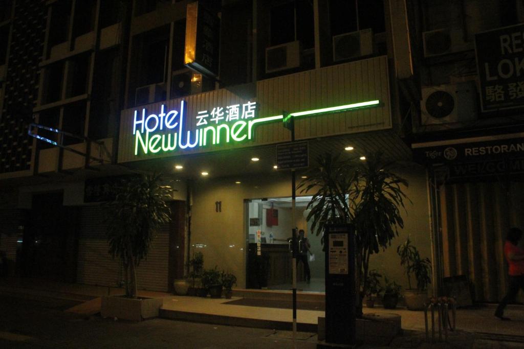 a hotel new member sign in front of a building at Hotel New Winner in Kuala Lumpur