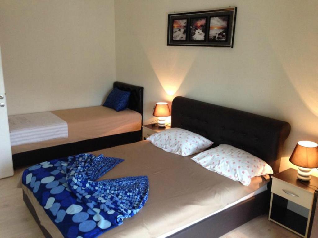 a bedroom with two beds with blue pillows at Fimi Apartments in Ulcinj
