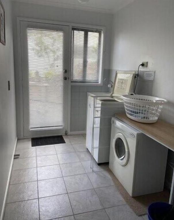 a kitchen with a washing machine and a washer at 36 Maurice Avenue in Mallacoota