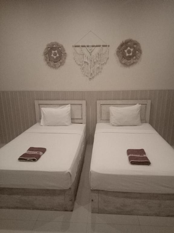 Postel nebo postele na pokoji v ubytování Wisma Bunda