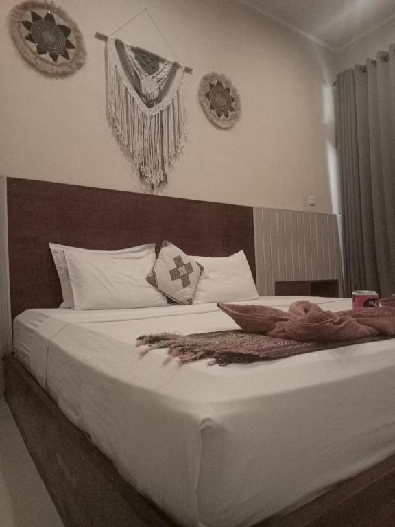 Postel nebo postele na pokoji v ubytování Wisma Bunda