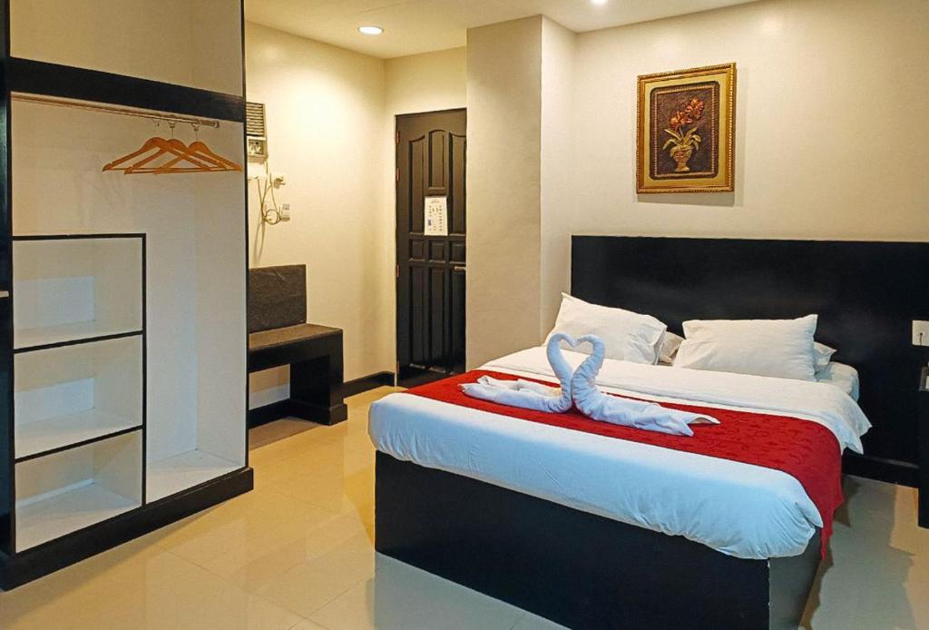Postel nebo postele na pokoji v ubytování Check Inn Hotel Dumaguete City by RedDoorz