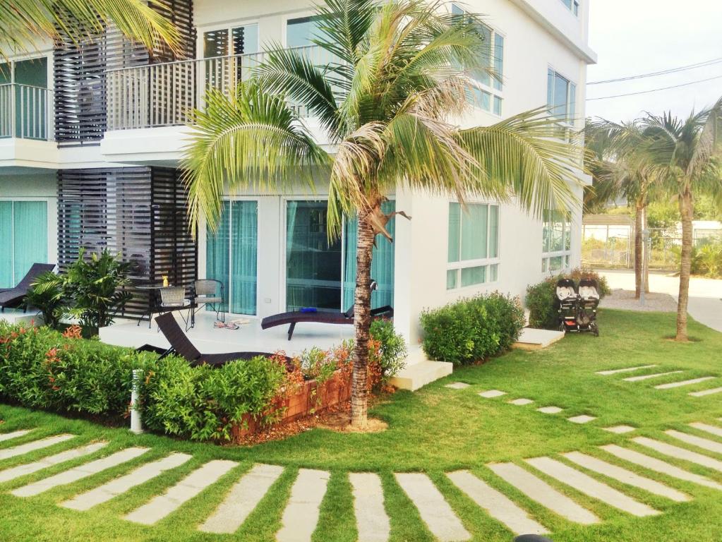 a palm tree in front of a building at The Sea Condominium A16 @ Dophin Bay, Pranburi in Ban Nong Khaem