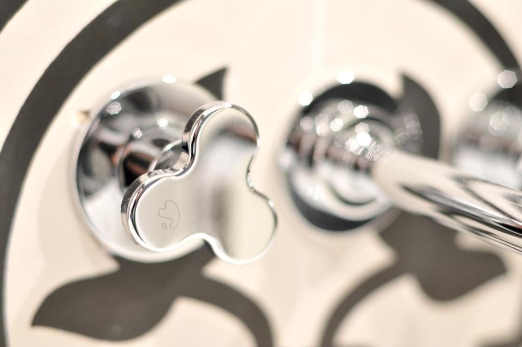 a close up of a bathroom sink with chrome faucet at L'Hôtel Particulier Beziers in Béziers