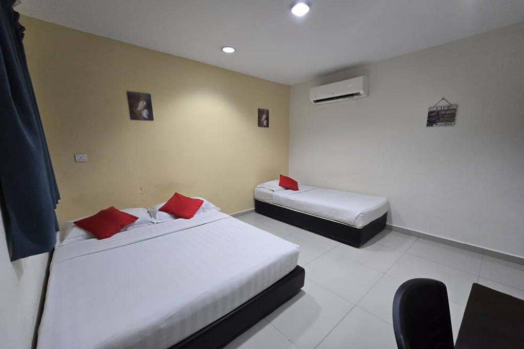 Postel nebo postele na pokoji v ubytování Hotel Inap Sri Gombak
