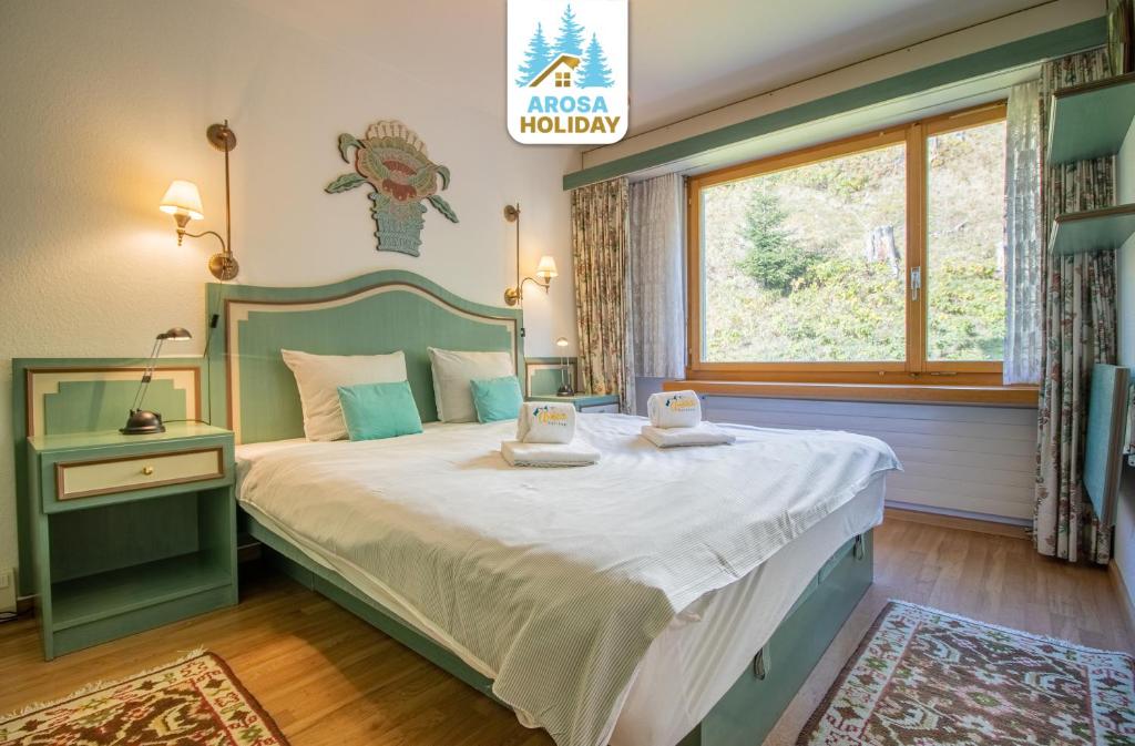 Postel nebo postele na pokoji v ubytování Rehwiesa 11C by Arosa Holiday