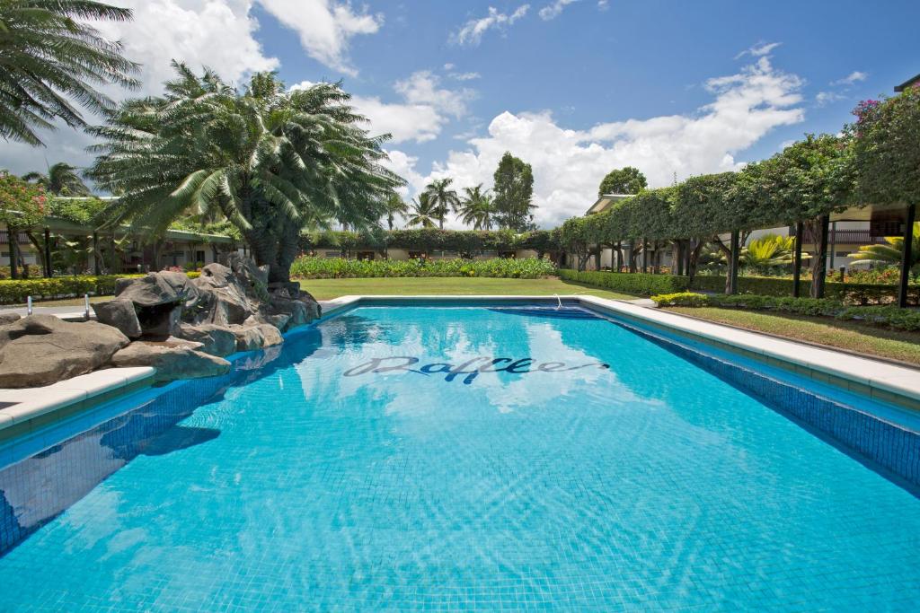 a large swimming pool with blue water at Fiji Gateway Hotel in Nadi